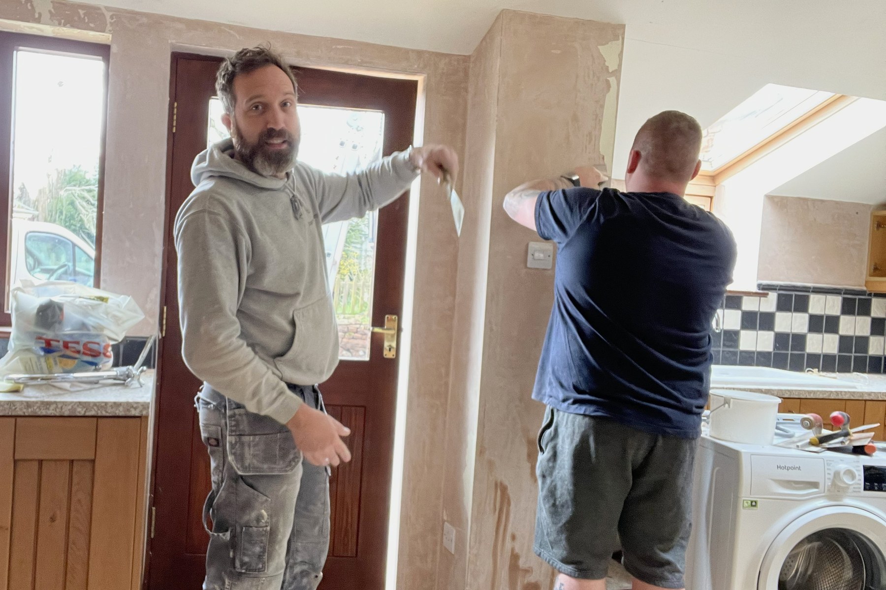 Jonathan Dee on site stripping walls during a property refurbishment